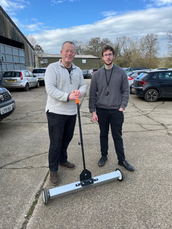 NDSR’s facilities manager Mark Woodham, left, and assistant Gregg Parsons-Dorman with the magnetic sweeper that has helped nail the hospital car park’s puncture problems. 